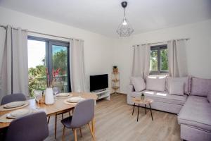 a living room with a table and a couch at Aella Apartment in Skala Kefalonias