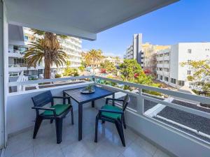 a patio with a table and chairs on a balcony at Ponderosa 210 Casa la Luna in Playa Fañabe