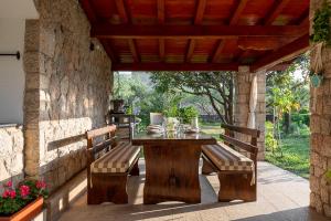 a wooden table and benches on a patio at Apartments Punta in Seline