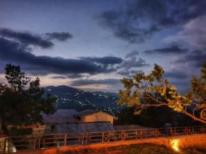 a view of a mountain at night with a fence at The Generals Inn in Murree