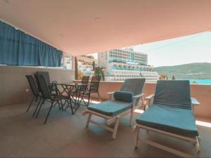 a balcony with chairs and a table and a cruise ship at Riba Fish Neum in Neum