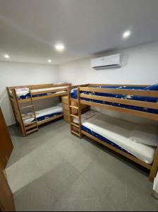 a room with three bunk beds in a room at Riba Fish Neum in Neum