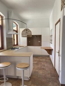 a kitchen with a counter and two stools in it at Casa Goro Formentera in Playa Migjorn