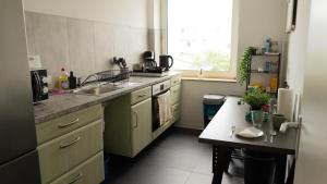 a kitchen with a sink and a table in it at 2 Zimmer Wohnung in Hannover in Hannover