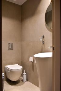 a bathroom with a toilet and a sink at JN VILLA in Agios Ioannis Kaspaka +23 photos