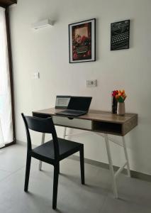 a desk with a laptop and a chair in a room at Lettera 22 Apartment in Brindisi +9 photos