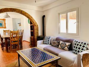 a living room with a couch and a table at Tarifa Townhouse in Tarifa