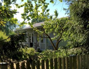 a house with a fence in front of it at Strandboende in Beddinge Strand