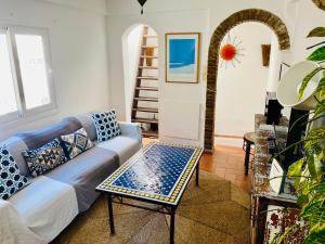 a living room with a couch and a table at Tarifa Townhouse in Tarifa