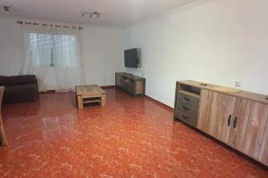 a living room with a couch and a tv and a table at Villa Maruna in Grao de Castellón
