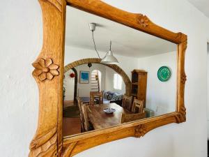 a mirror hanging on a wall with a dining room at Tarifa Townhouse in Tarifa
