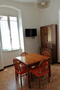 a dining room with a wooden table and chairs at Domo Nina in La Spezia