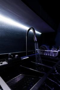 a kitchen sink with water coming out of a faucet at The Palm Terrace Penthouse 3BR - Palm Hills - 280 sqm in Cairo