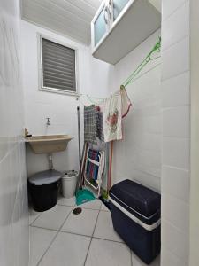 a small bathroom with a sink and a toilet at Apartamento Peruibe pé na areia!!! in Peruíbe +15 photos