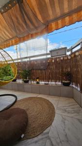 a patio with a large window and a large rug at Résidences C-Irène Angré in Abidjan +88 photos