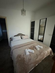 a bedroom with a bed with two white towels on it at House with big terrace near the beach in Kotor