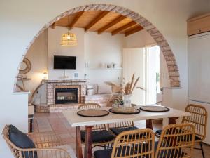 a living room with a table and chairs and a fireplace at Trip's House: εξοχικό σπίτι με θέα στη θάλασσα. in Ambelas