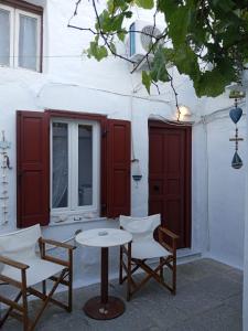 a table and chairs sitting in front of a building at Marthas Traditional House in Symi