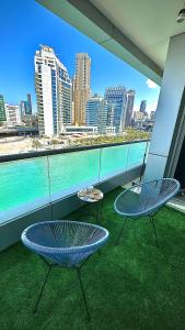 a balcony with two chairs and a view of the city at Wonderful two bed room with full marina view in Dubai