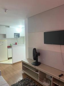 a living room with a flat screen tv on a wall at Milenium residence 206 in Juiz de Fora