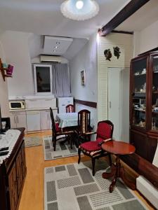 a kitchen with a table and chairs and a dining room at Zemun Centre Loft in Zemun