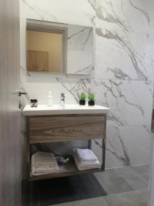 a bathroom with a sink and a mirror at Anel Rooms in Himare