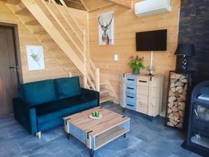 a living room with a couch and a coffee table at Domek przy lesie na Roztoczu in AdamÃ³w