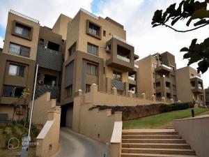 an apartment building with stairs in front of it at The Palm Terrace Penthouse 3BR - Palm Hills - 280 sqm in Cairo