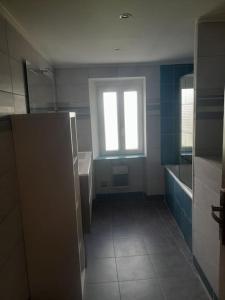 a bathroom with a sink and a window in it at Maison Saint Côme du Mont in Saint-Côme-du-Mont