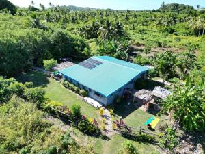 an overhead view of a house with a blue roof at Ravita Cove HomeAway from Home HomeStay in Matacawalevu