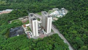 an overhead view of two tall buildings in a forest at Suíte Privativa Via Premiere - Barra Olímpica, Rio Centro, Rock in Rio, Carnaval in Rio de Janeiro