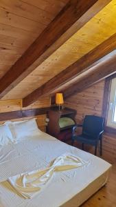 a bedroom with a bed and a chair at Sol Apartments Gjiri Lalzit in Durrës