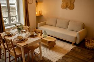 a living room with a couch and a table at La halte ducale #1 in Charleville-Mézières