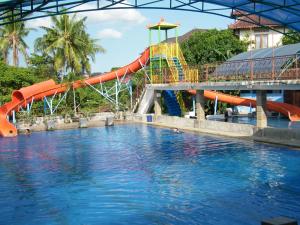 a water park with a slide in the water at Betesda Guest House in Canggu