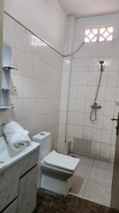 a white bathroom with a toilet and a shower at Diadia Apartment 2 in Dakar +7 photos