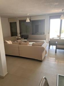 a living room with two large couches and a couch at Front Sea Villa Polichrono in Kriopigi