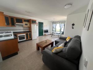 a living room with a couch and a kitchen at Casa La Estrella Playa Blanca Lanzarote in Playa Blanca