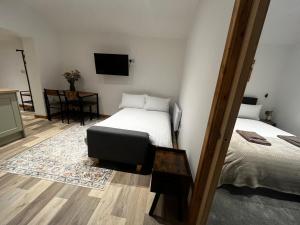 a bedroom with a bed and a television on the wall at Small home in Llanfairpwll in Llanfairpwllgwyngyll