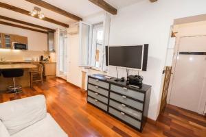 a living room with a tv on top of a dresser at Abbesses Montmartre Apartment in Paris