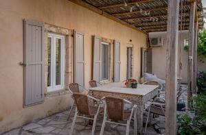 a patio with a table and chairs on a porch at Militiko in Himare