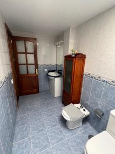 a bathroom with a toilet and a sink at Casa La Estrella Playa Blanca Lanzarote in Playa Blanca +13 photos