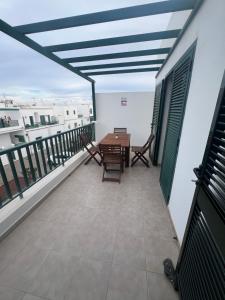 a balcony with a table and chairs on a building at Casa La Estrella Playa Blanca Lanzarote in Playa Blanca