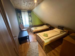 a small room with two beds and a window at Guļbūve ar saunu, kamīnu in Saulkrasti