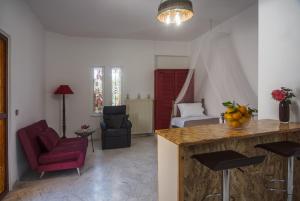 a kitchen with a counter and a living room at Liza's Place in Metókhion +32 photos