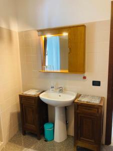a bathroom with a sink and a mirror at Casa nella natura a Bobbio in Bobbio