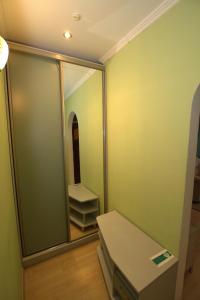 a dressing room with a mirror and a shelf at Intourist Hotel in Brest