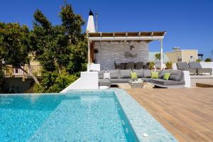 a backyard with a swimming pool and a villa at Secret Spot Luxury Villa in Fira