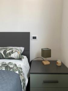 a bedroom with a bed and a lamp on a nightstand at Casa Elefantino in Acilia