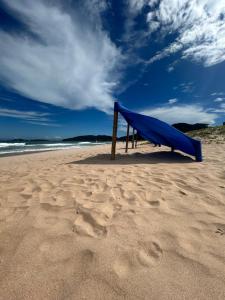 un tobogán azul sentado en una playa de arena en Búzios beach resort en Búzios