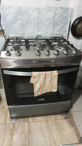 a stove top oven with a towel on it at CHAVIN inn with kitchen compartida Lima in Lima